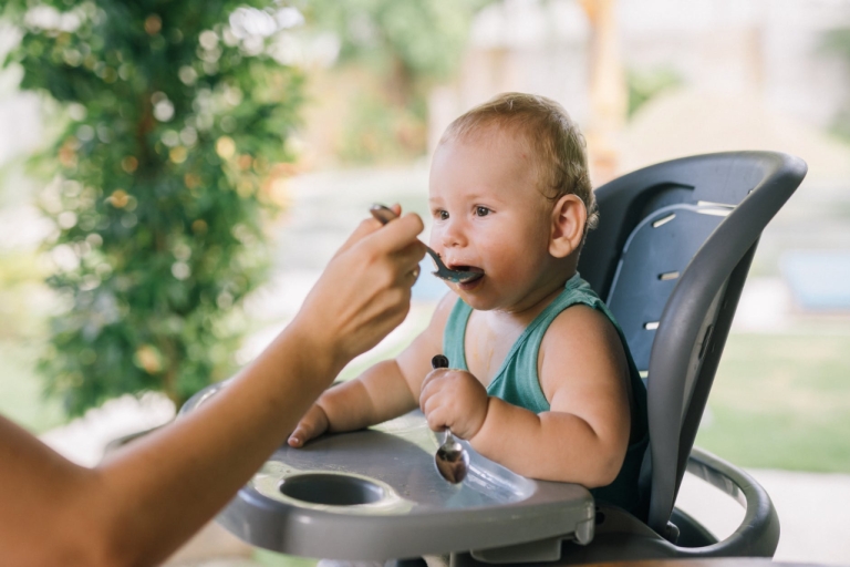 Baby eating in highchair
