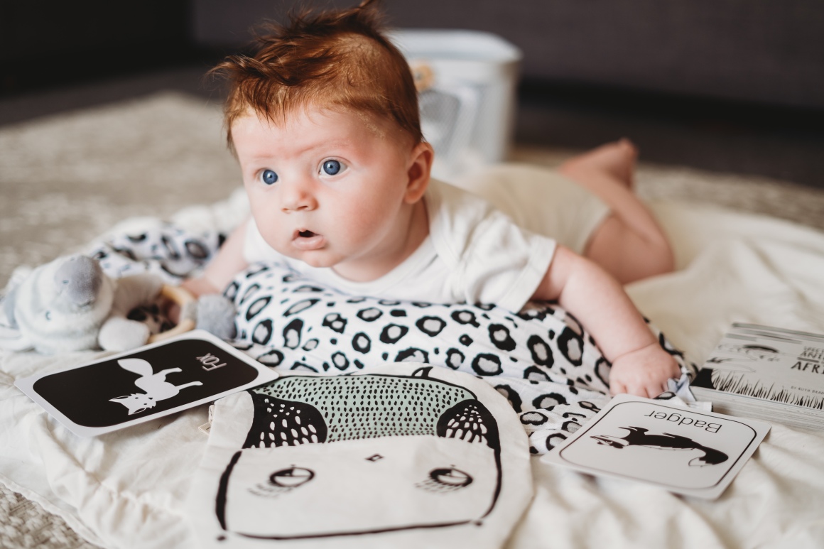 A baby with black and white sensory toys 